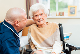 Nurse looking after dementia resident in care home in Glasgow